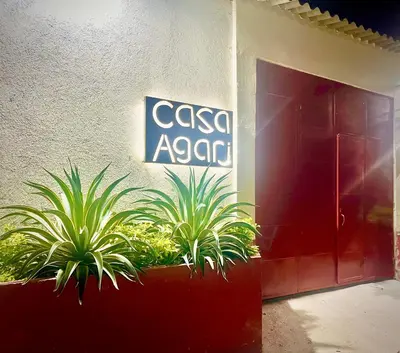 a sign on the side of a building with plants at Casa Agarj in Santa Marta