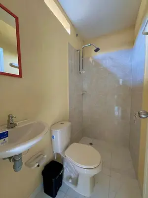 a bathroom with a toilet and a sink and a shower at Casa Agarj in Santa Marta