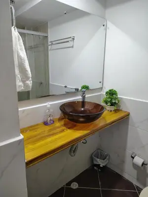 a bathroom with a wooden sink and a mirror at Acojedor apto en coveñas in Coveñas