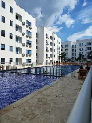 a swimming pool in front of a building at Acojedor apto en coveñas in Coveñas