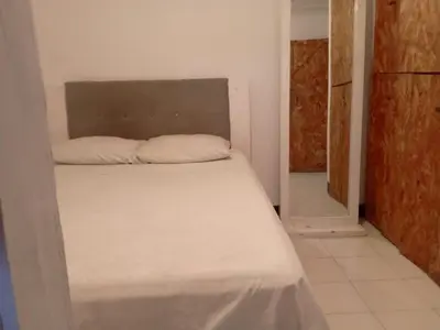 a bedroom with a bed in a room with a mirror at Shantyhostal in Cartagena de Indias