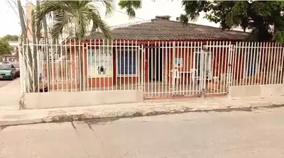 a white fence in front of a red building at Shantyhostal in Cartagena de Indias