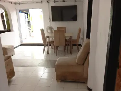 a living room with a table and a couch and a television at Shantyhostal in Cartagena de Indias