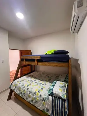 a bedroom with a bunk bed in a room at Villa Manglar in Coveñas