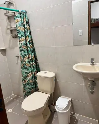 a bathroom with a toilet and a sink at Villa Manglar in Coveñas