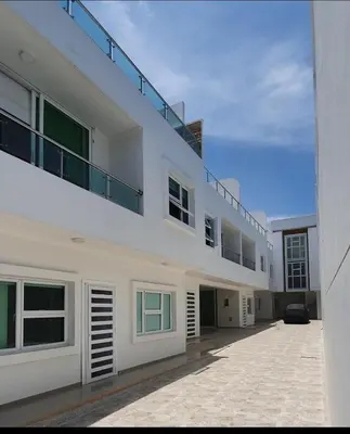 a white building with a balcony on top of it at Aparta estudio Malecón del Río in Barranquilla