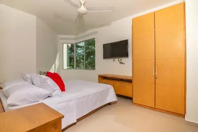 a bedroom with a bed and a flat screen tv at Magico Apartamento Frente al Mar 2 Habitaciones B11B in Coveñitas