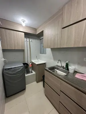 a small kitchen with a sink and a sink at Comfortable 2 bedroom apartment with pool in Miramar in Barranquilla