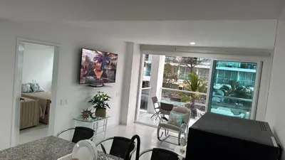 a living room with a television and a room with a balcony at ESPECTACULAR APARTAMENTO MORROS 3 Acceso directo a la Playa!!! in Cartagena de Indias