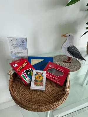 a table with books and a bird on top of it at ESPECTACULAR APARTAMENTO MORROS 3 Acceso directo a la Playa!!! in Cartagena de Indias
