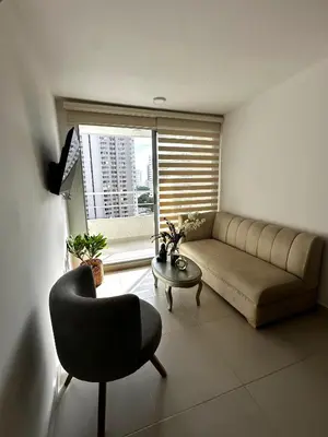 a living room with a couch and a chair and a window at Apartamento en Torices in Cartagena de Indias