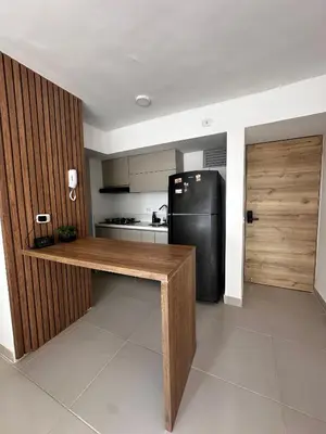 a kitchen with a black refrigerator and a wooden counter at Apartamento en Torices in Cartagena de Indias