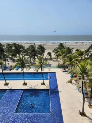 a view of the beach from a resort with palm trees at Apartamento en Cartagena con vista al mar in Cartagena de Indias