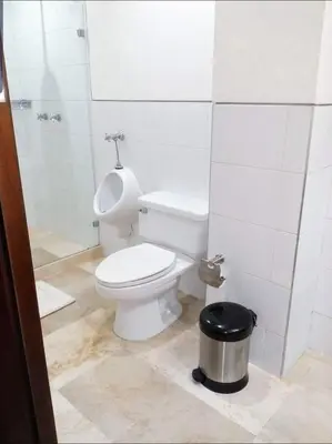 a white bathroom with a toilet and a shower at Apartamento en Cartagena con vista al mar in Cartagena de Indias
