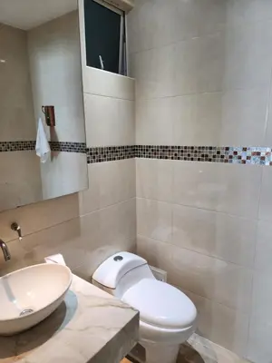 a bathroom with a white toilet and a sink at Apartamento en Cartagena con vista al mar in Cartagena de Indias