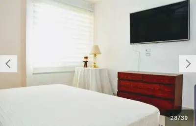 a bedroom with a bed and a flat screen tv at Apartamento en Cartagena con vista al mar in Cartagena de Indias
