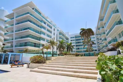 a staircase in front of a building with palm trees at Apartamento vista al mar cartagena Edificio Morros in Cartagena de Indias