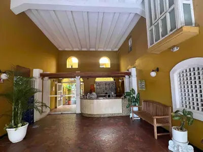 a restaurant with a counter in a room with plants at Beautiful duplex in the historic center! in Cartagena de Indias