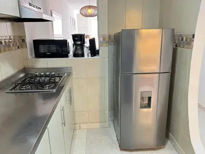 a kitchen with a stainless steel refrigerator and a stove at Beautiful duplex in the historic center! in Cartagena de Indias
