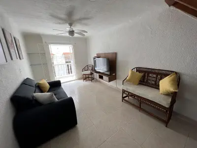 a living room with a couch and a tv at Beautiful duplex in the historic center! in Cartagena de Indias