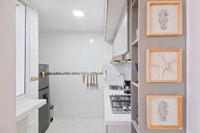 a kitchen with two framed drawings of starfish on the wall at Hermoso apartamento en manga piso 3 in Cartagena de Indias