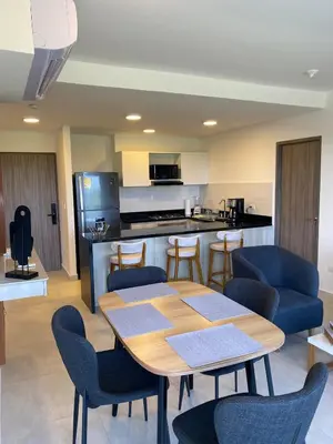a dining room with a table and chairs and a kitchen at Castelo - Serena Del Mar in Puerto Tierrabaja