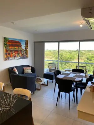 a living room with a couch and a table and chairs at Castelo - Serena Del Mar in Puerto Tierrabaja