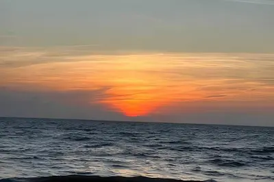 a sunset over the ocean with a cloudy sky at Tu Casa de playa frente al mar, Tolú te espera in Tolú