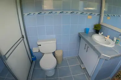 a bathroom with a toilet and a sink at Tu Casa de playa frente al mar, Tolú te espera in Tolú