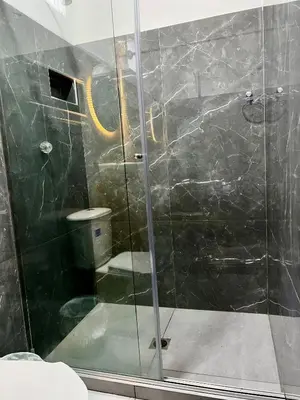 a bathroom with a glass shower with a toilet at Sol de Coveñas Caracol in Guayabal