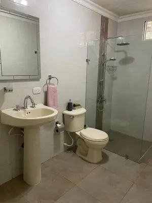 a bathroom with a toilet and a sink and a shower at Casa Estela in Cartagena de Indias