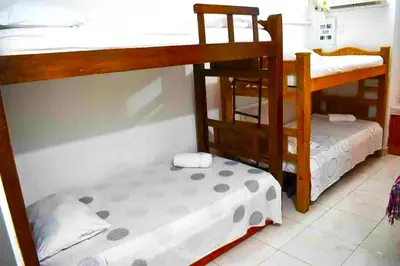 a bedroom with two bunk beds and a small bed at Casa Vilmar Getsemani in Cartagena de Indias