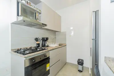 a kitchen with a stove and a microwave at Modern Apartment in Santa Marta in Santa Marta