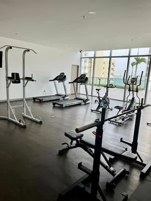 a gym with several tread machines in a room at Bocagrande bay view gym jacuzzi pool in Cartagena de Indias