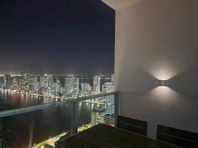a room with a view of a city at night at Bocagrande bay view gym jacuzzi pool in Cartagena de Indias