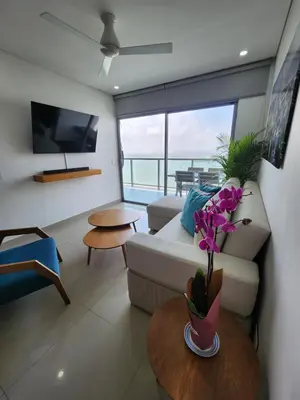 a living room with a couch and a table at Bocagrande bay view gym jacuzzi pool in Cartagena de Indias