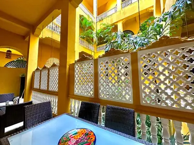 a dining room with a blue table and chairs at by Calamari Homes - El Porvenir 207 walled city in Cartagena de Indias