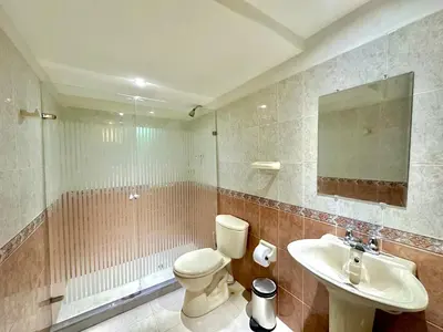 a bathroom with a toilet and a sink and a mirror at by Calamari Homes - El Porvenir 207 walled city in Cartagena de Indias
