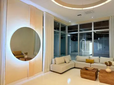 a living room with a couch and a round mirror at Modern Apartasuit Cartagena Beach in Cartagena de Indias