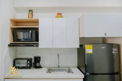 a kitchen with a stainless steel refrigerator and a microwave at Modern Apartasuit Cartagena Beach in Cartagena de Indias