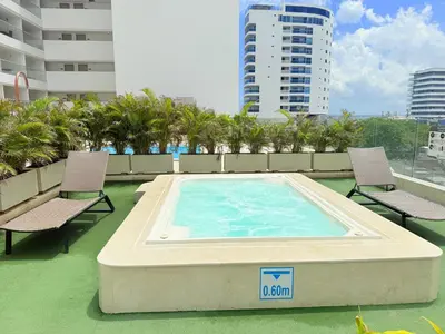 a swimming pool on the roof of a building at Modern Apartasuit Cartagena Beach in Cartagena de Indias