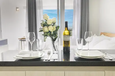 a table with a bottle of wine and a vase of flowers at Apartasuit Cartagena luxury 1240 in Cartagena de Indias