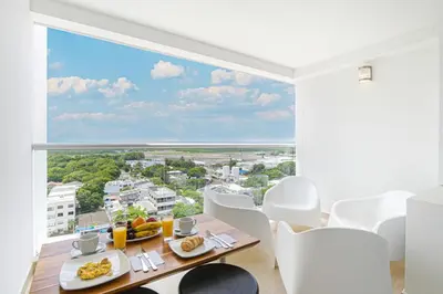 a dining room with a view of the ocean at Apartasuit Cartagena luxury 1240 in Cartagena de Indias