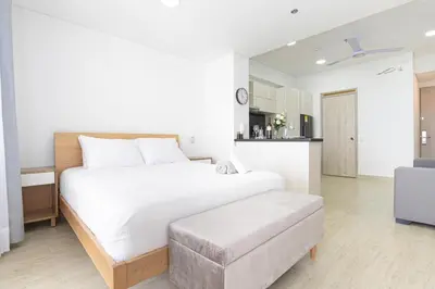 a white bedroom with a large bed and a couch at Luxurious Apartasuit CartagenaBeach1139 in Cartagena de Indias