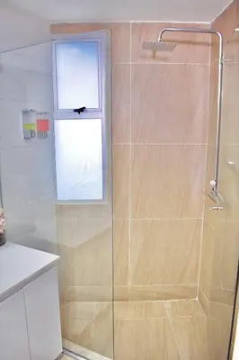 a bathroom with a glass shower with a window at Exclusivo apartamento de lujo frente al mar en Los Morros, con acceso directo y privado a la mejor playa de Cartagena in Cartagena de Indias