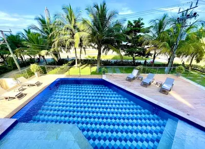 a swimming pool with two chairs and a pool at Exclusivo apartamento de lujo frente al mar en Los Morros, con acceso directo y privado a la mejor playa de Cartagena in Cartagena de Indias