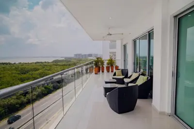 a balcony with chairs and a view of the ocean at Beachfront Condo in Cartagena in Cartagena de Indias