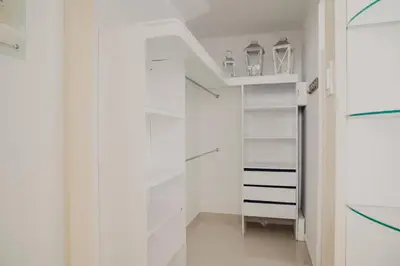 a white walk in closet with white shelves at Beachfront Condo in Cartagena in Cartagena de Indias