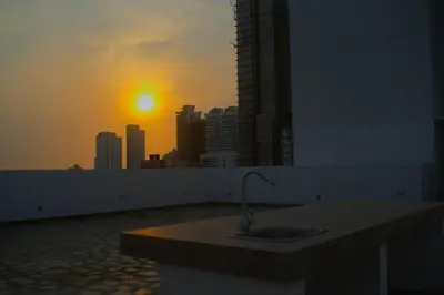 a bathroom with a sink with the sunset in the background at Hermoso Apartamento Cerca a Playa in Cartagena de Indias