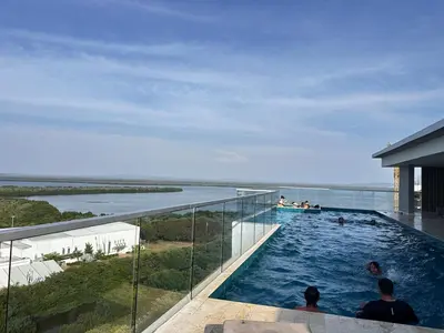 a swimming pool on top of a building with people in it at Premium Hub 1304 APARTAMENTO CARTAGENA Vista al Mar in Cartagena de Indias